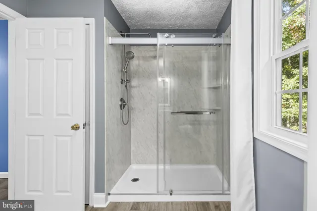a bathroom with a glass shower door