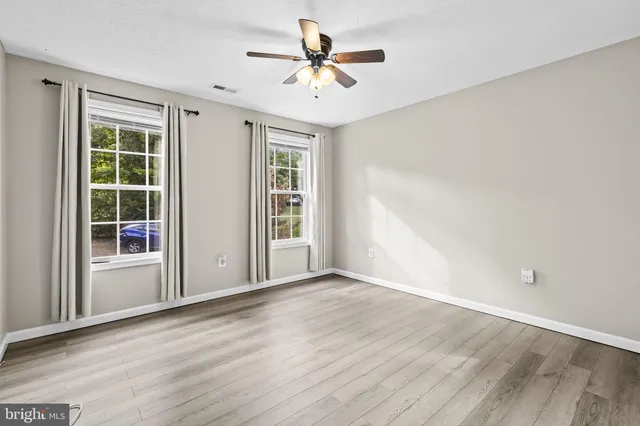 wooden floor in an empty room with a window