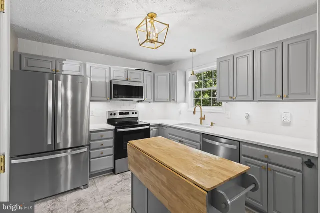 a kitchen with a refrigerator and a sink