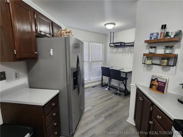 a kitchen with a refrigerator and a sink