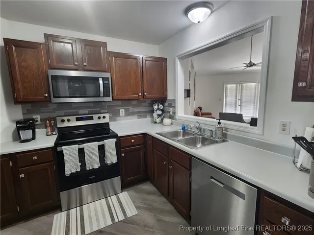 a kitchen with a sink stove and microwave