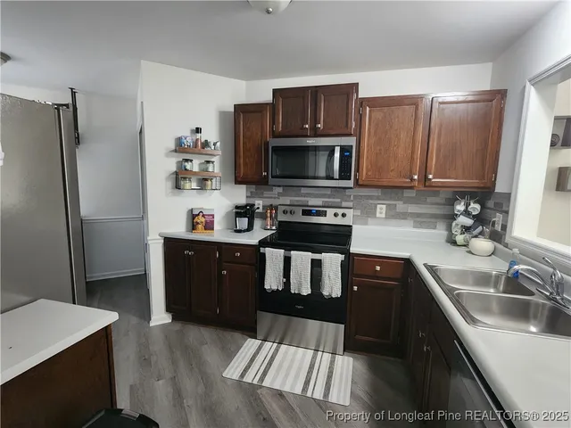 a kitchen with a sink stove and refrigerator
