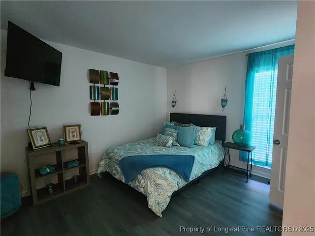 a bed sitting in a bedroom next to a window