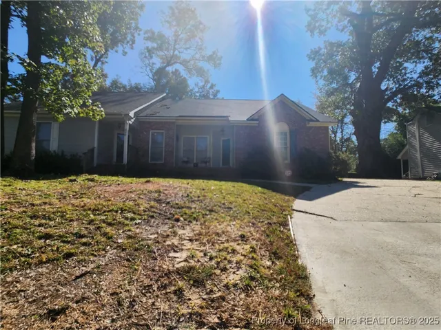 a view of a yard with large trees