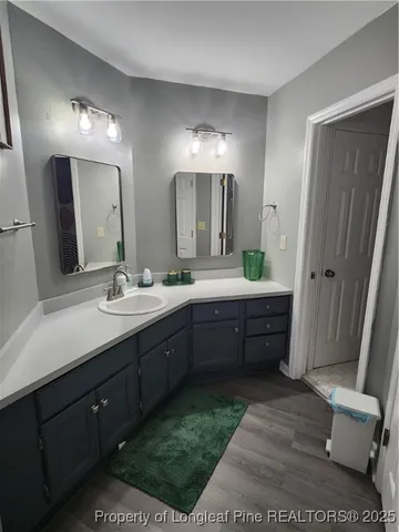 a bathroom with a double vanity sink mirror double and toilet