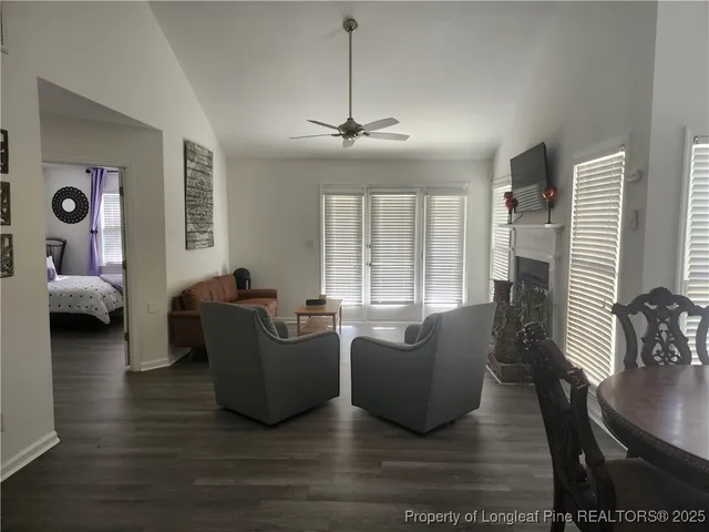 a living room with furniture and a chandelier