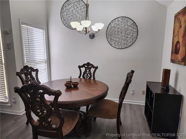 a view of a dining room with furniture and chandelier