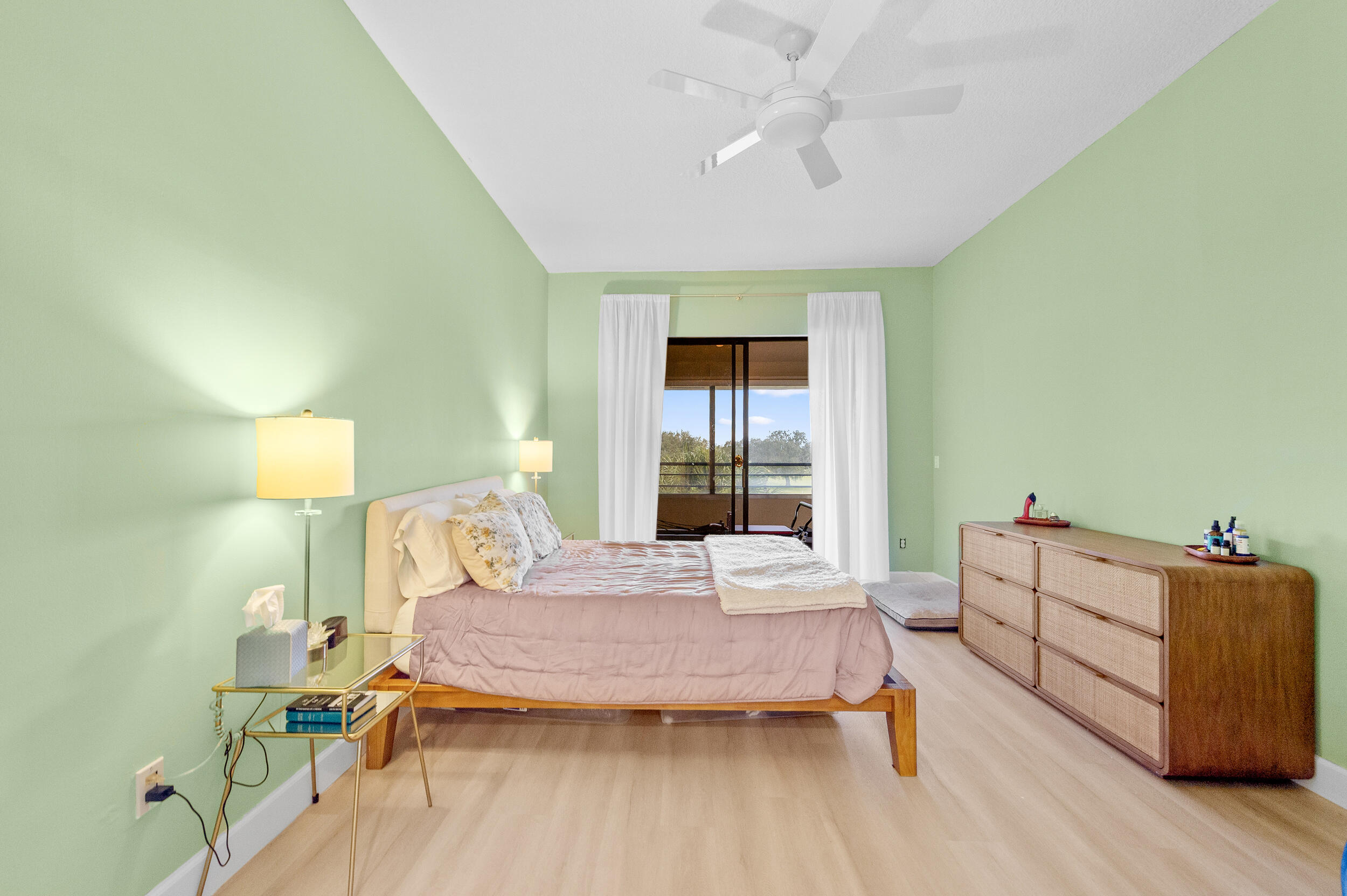 7460 La Paz Boulevard, Unit 304 Boca Raton, FL 33433 - Photo 12 of 37 a bedroom with a bed and wooden floor