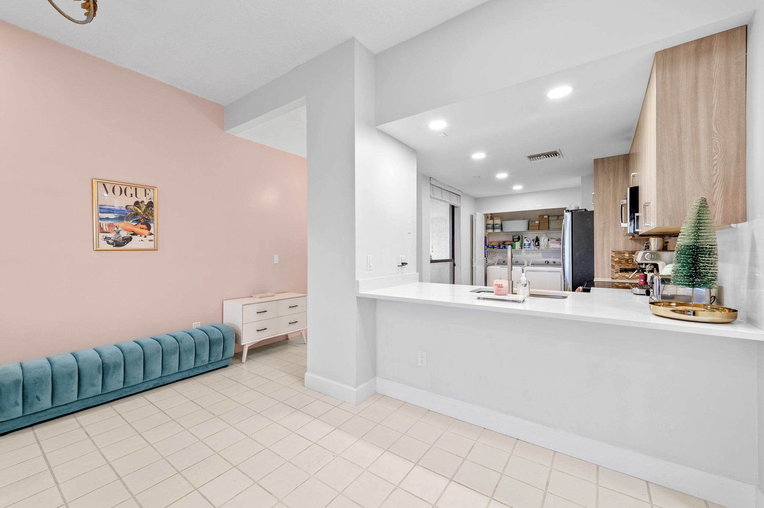 7460 La Paz Boulevard, Unit 304 Boca Raton, FL 33433 - Photo 27 of 37 a kitchen with stainless steel appliances kitchen island sink refrigerator and stove