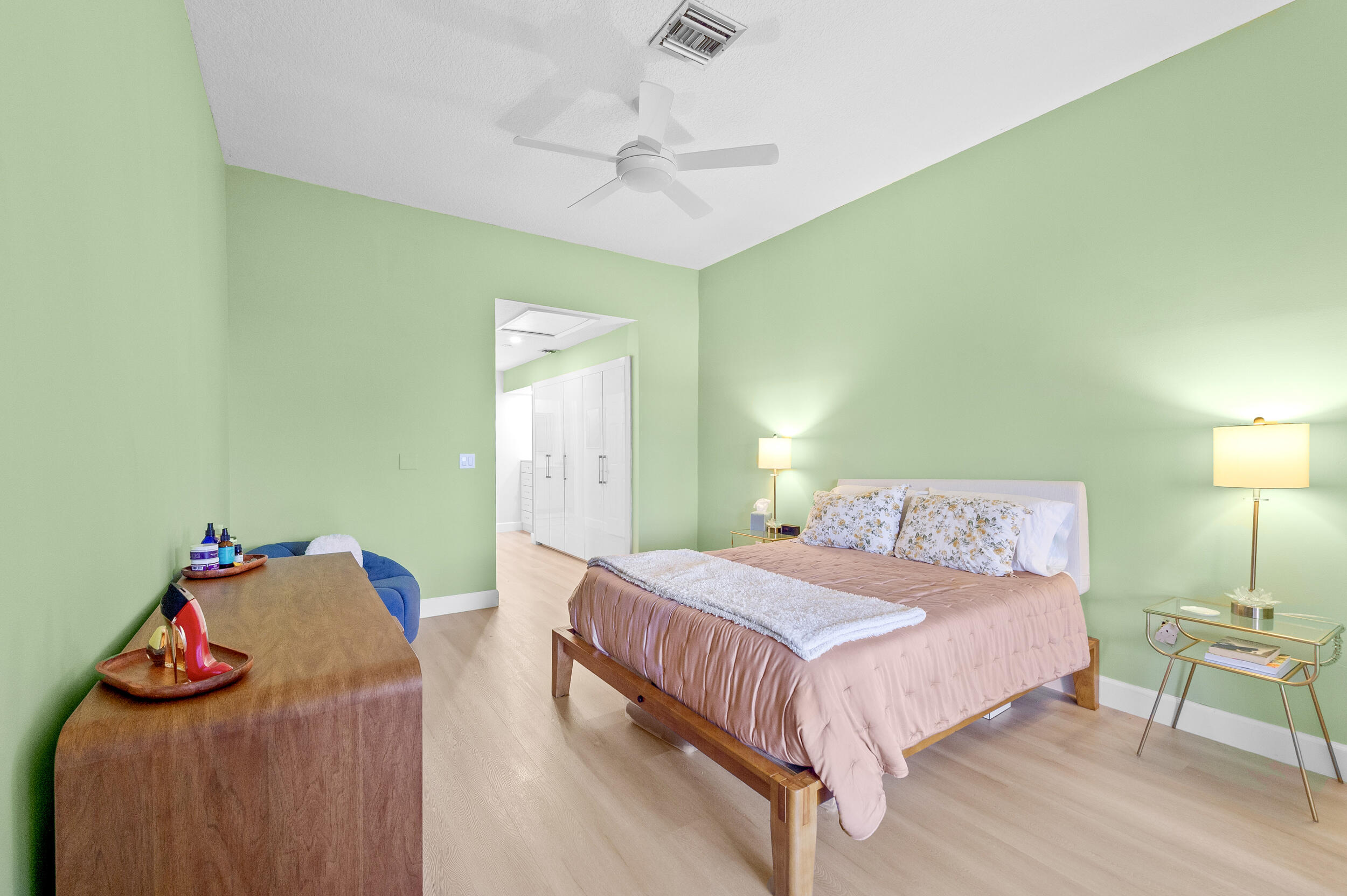 7460 La Paz Boulevard, Unit 304 Boca Raton, FL 33433 - Photo 33 of 37 a bedroom with a bed and chandelier