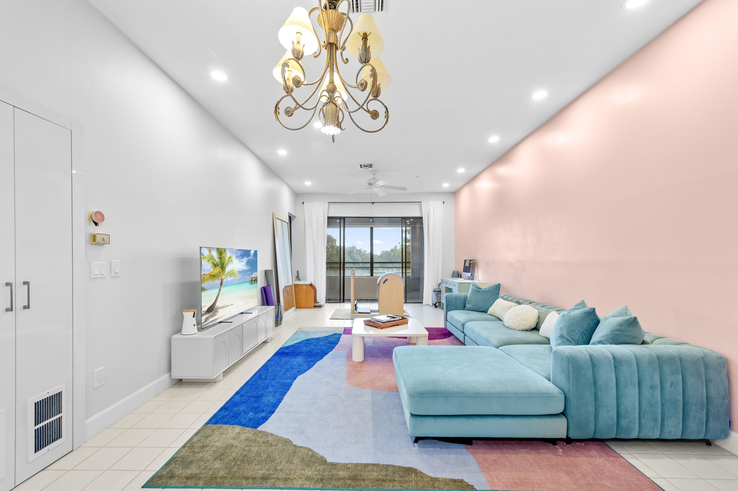 7460 La Paz Boulevard, Unit 304 Boca Raton, FL 33433 - Photo 35 of 37 a living room with furniture and a chandelier