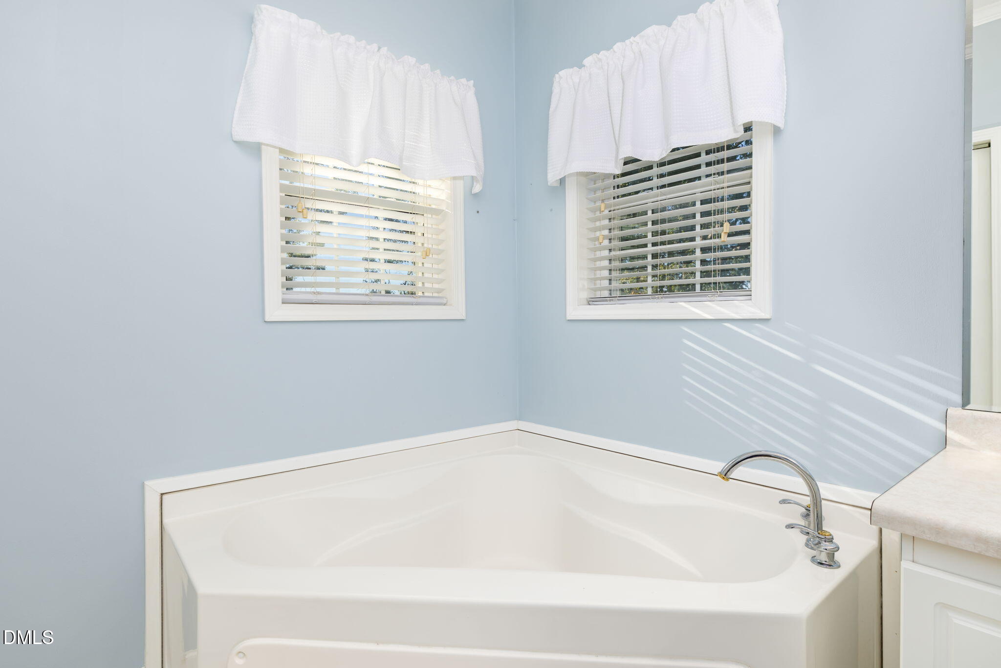 3900 Dabney Road Henderson, NC 27537 - Photo 16 of 35 a white bath tub sitting next to a window