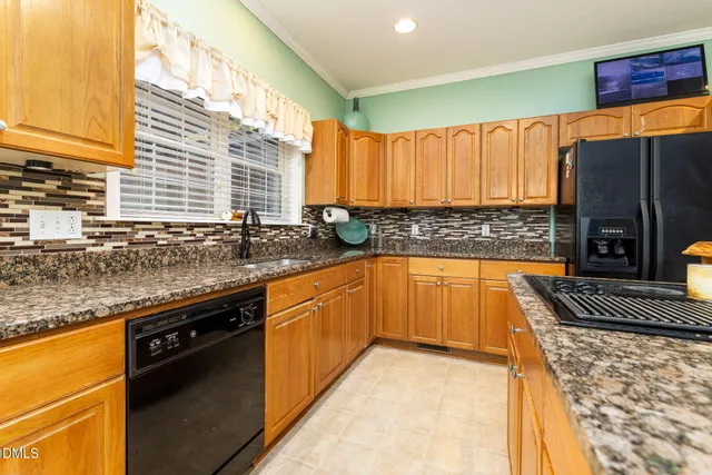 a kitchen with granite countertop a sink and a stove