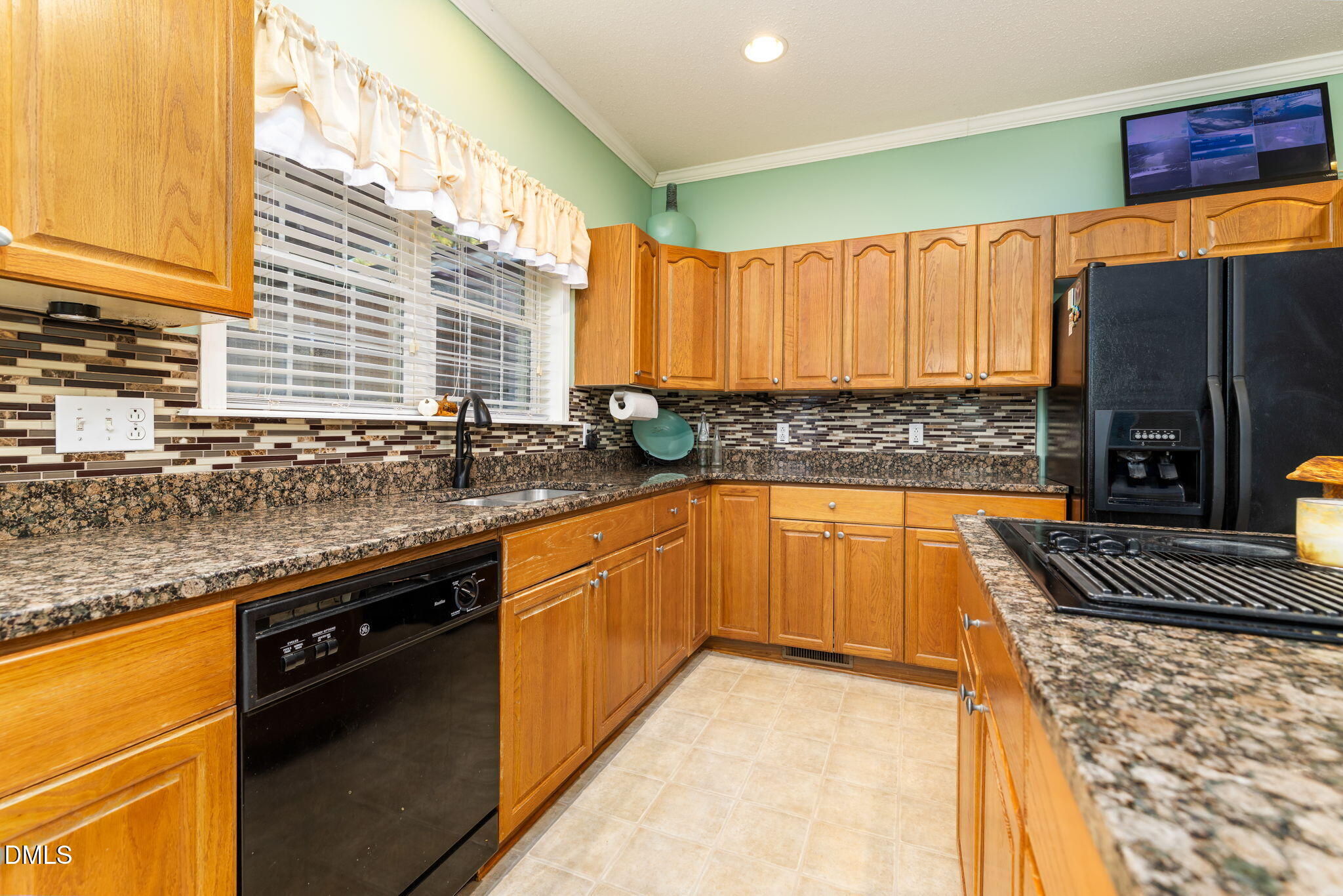 3900 Dabney Road Henderson, NC 27537 - Photo 6 of 35 a kitchen with granite countertop a sink and a stove