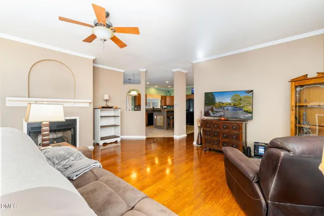 a living room with furniture a fireplace and a flat screen tv