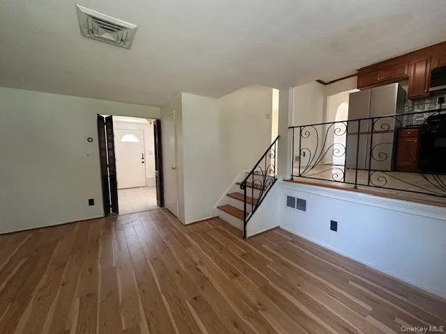 a view of staircase with white walls and a window
