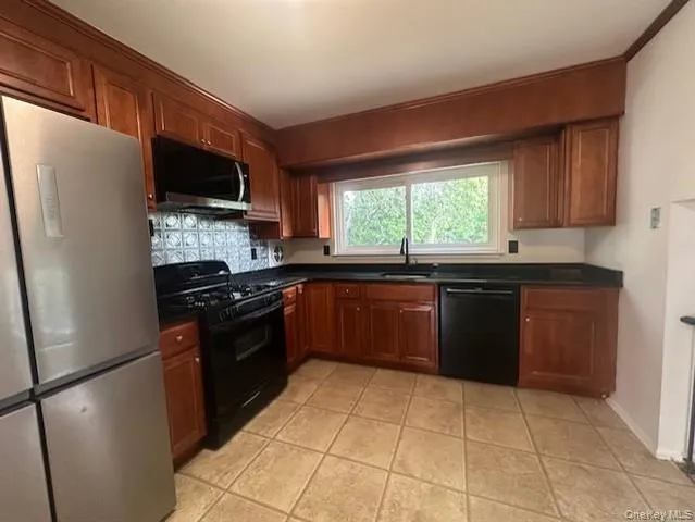 a kitchen with a sink stove and refrigerator