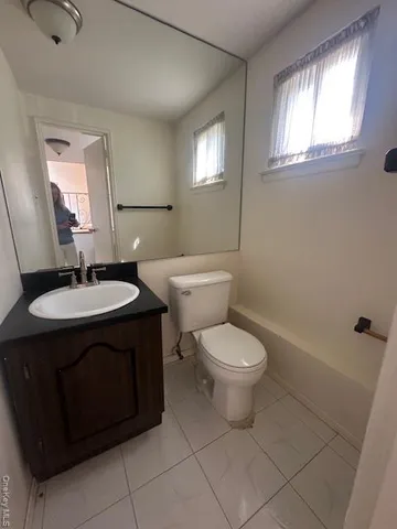 a bathroom with a sink toilet and mirror