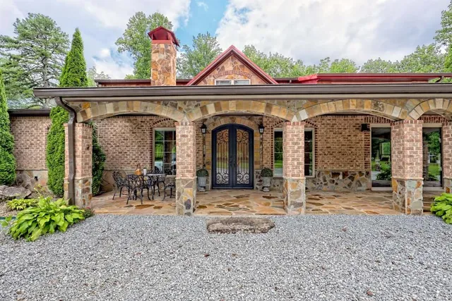 a living room with fireplace furniture and a large window