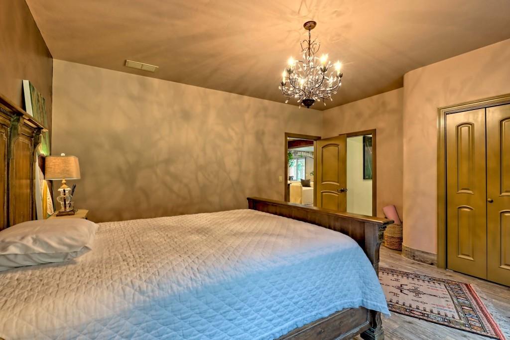 1422 Wolffork Road Rabun Gap, GA 30568 - Photo 23 of 78 a bedroom with a bed chandelier and a window