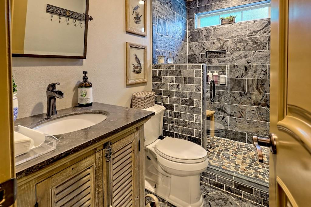 1422 Wolffork Road Rabun Gap, GA 30568 - Photo 24 of 78 a bathroom with a granite countertop toilet sink and mirror