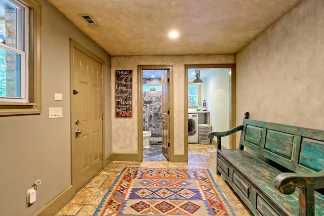 a view of a house with a yard and large trees