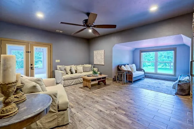 a view of a patio with a table and chairs and floor to ceiling window