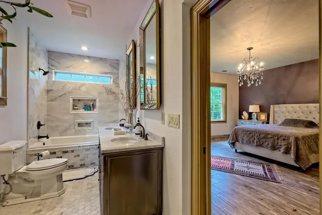 an aerial view of green landscape with trees houses and mountain view