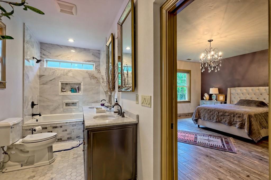 1422 Wolffork Road Rabun Gap, GA 30568 - Photo 45 of 78 a en suite bathroom with a double vanity sink and a mirror