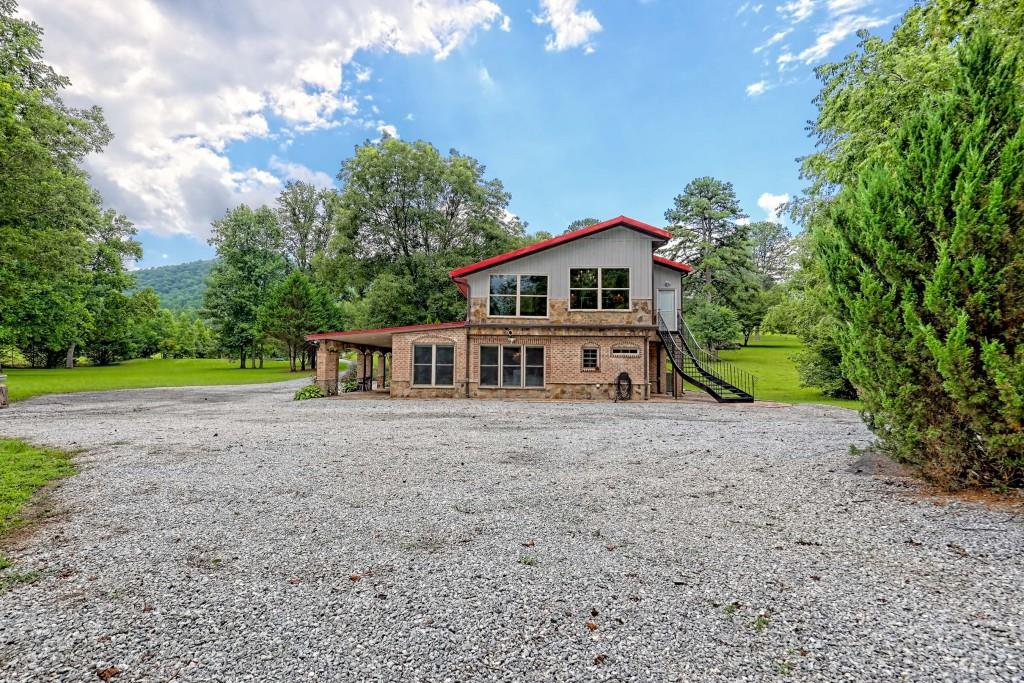 1422 Wolffork Road Rabun Gap, GA 30568 - Photo 52 of 78 a view of a house with a yard and large trees