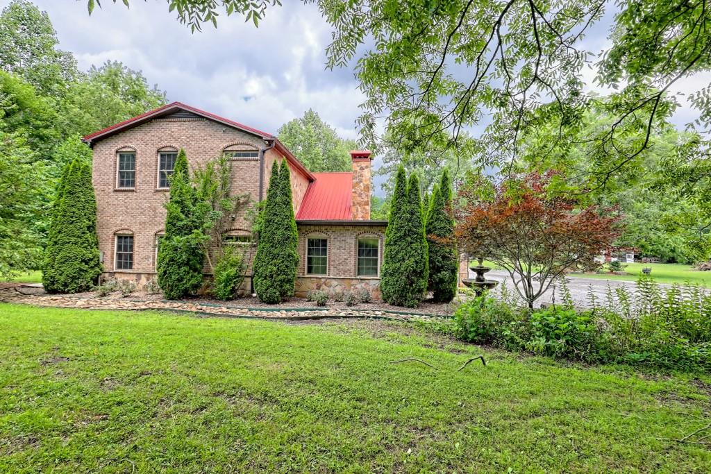 1422 Wolffork Road Rabun Gap, GA 30568 - Photo 59 of 78 a front view of a house with a yard and trees