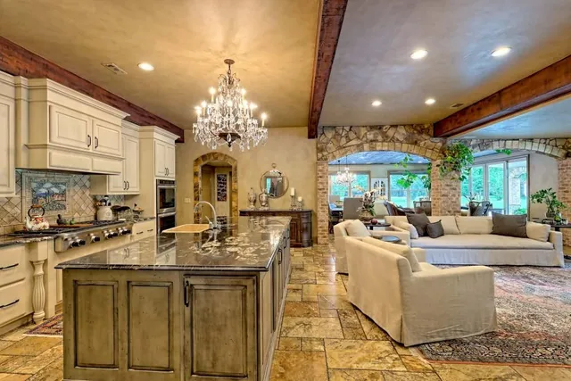 a view of a dining room with furniture a chandelier and wooden floor