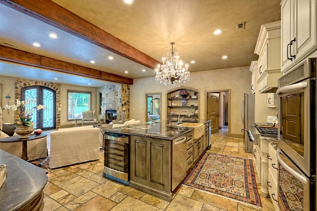 1422 Wolffork Road Rabun Gap, GA 30568 - Photo 9 of 78 a living room with stainless steel appliances kitchen island granite countertop furniture a rug and a chandelier