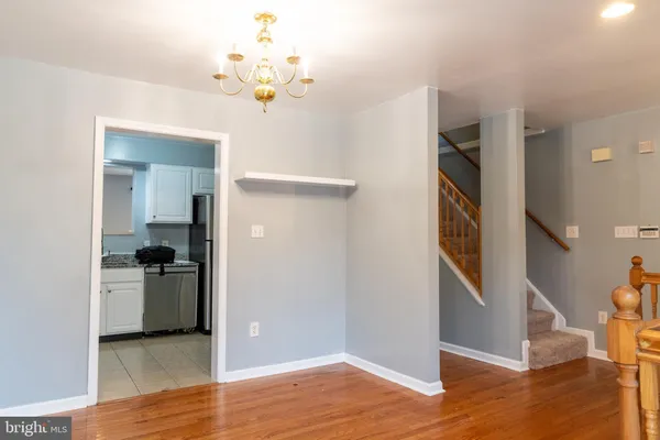 wooden floor in an empty room with a bathroom