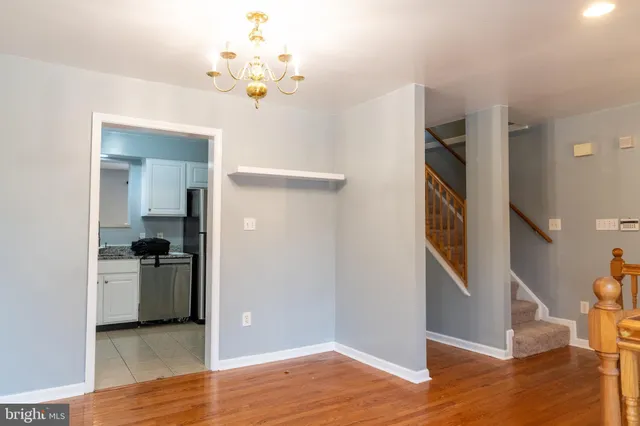 wooden floor in an empty room with a bathroom