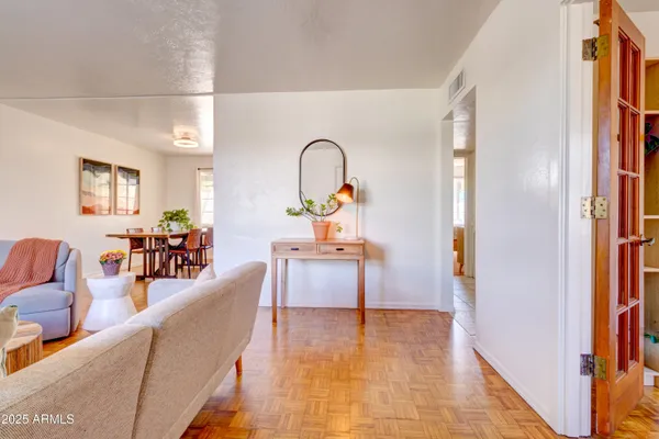 a living room with furniture and a wooden floor