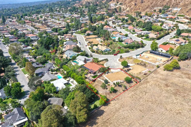 an aerial view of residential houses with outdoor space