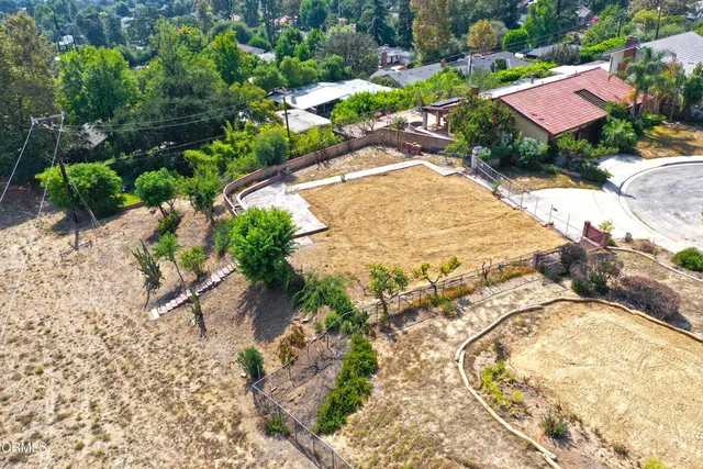an aerial view of residential houses with outdoor space