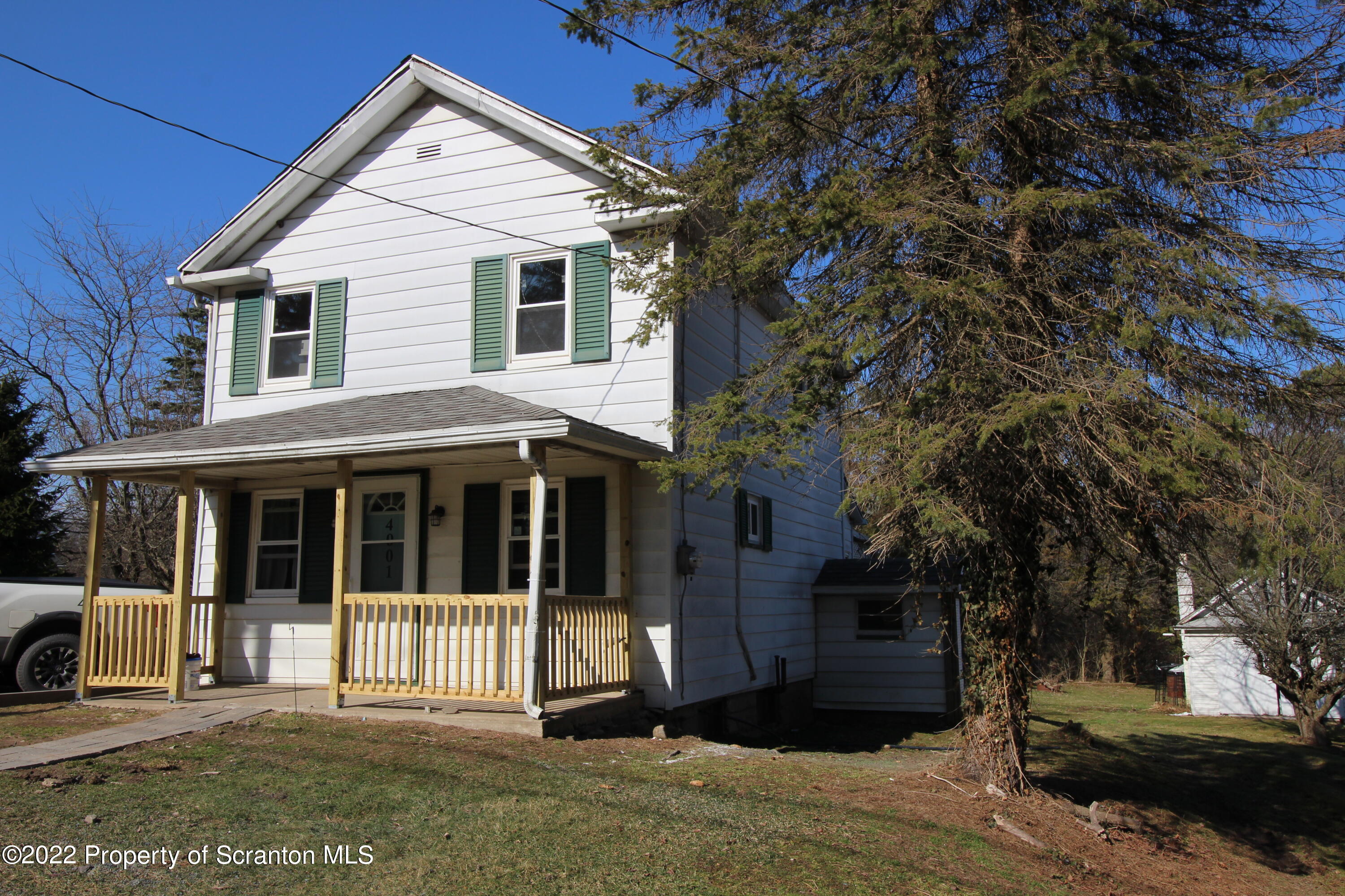 4001 Quicktown Road Moscow, PA 18444 - Photo 1 of 24 a view of a white house with large windows and a small yard