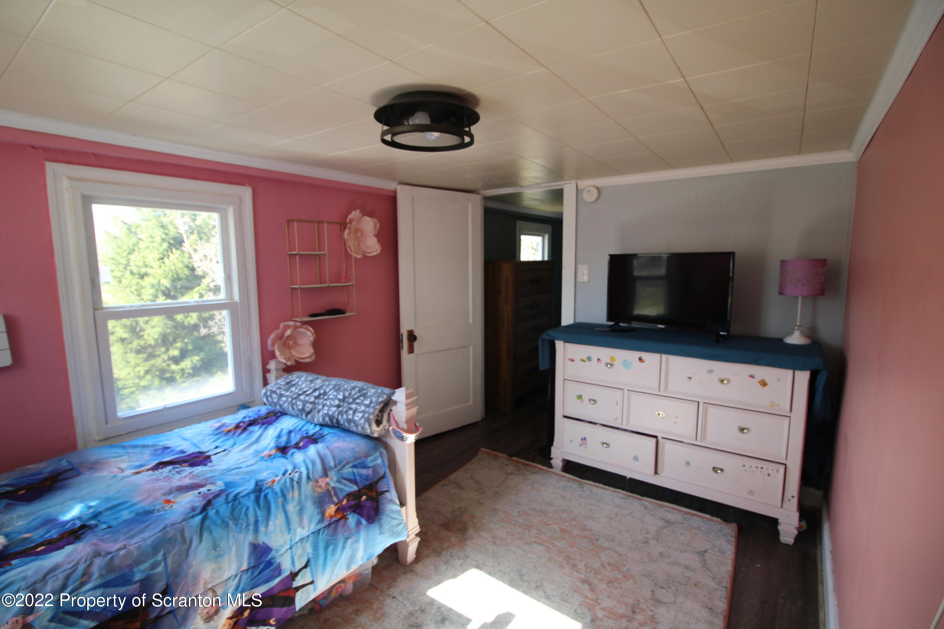 4001 Quicktown Road Moscow, PA 18444 - Photo 19 of 24 a bedroom with a bed and a flat screen tv