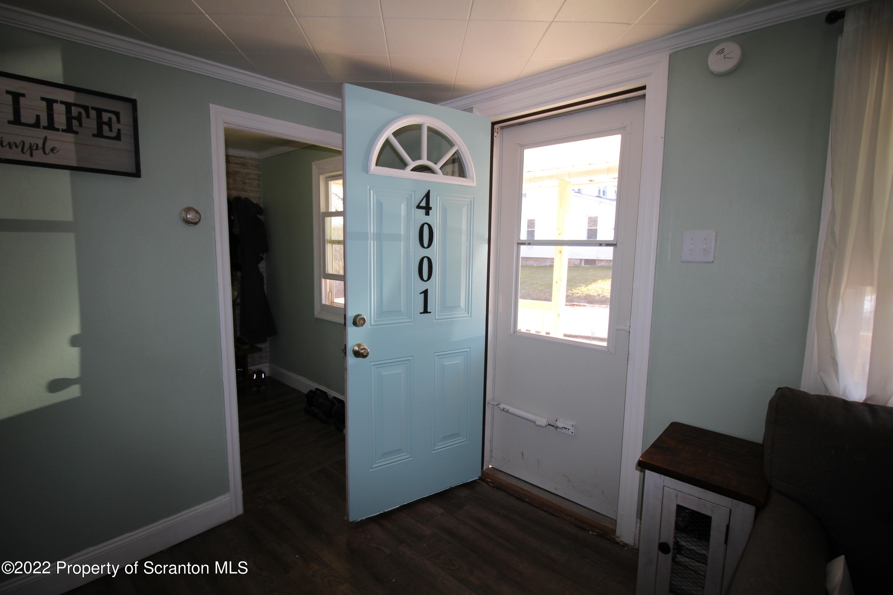 4001 Quicktown Road Moscow, PA 18444 - Photo 2 of 24 a view of a hallway with wooden floor and a livingroom