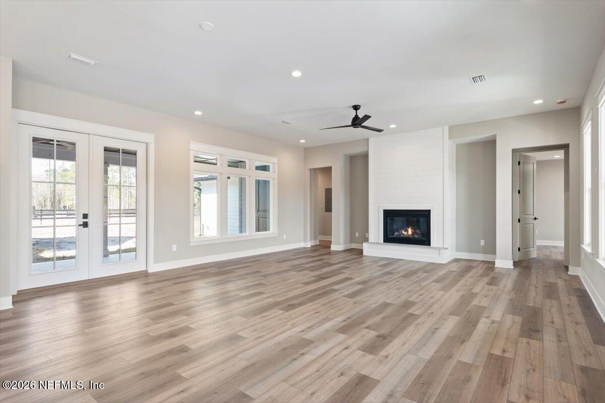 34883 Steeple Chase Way Callahan, FL 32011 - Photo 12 of 88 a view of an empty room with wooden floor and a window
