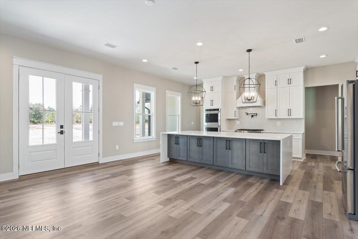 34883 Steeple Chase Way Callahan, FL 32011 - Photo 13 of 88 a large kitchen with a large window and stainless steel appliances