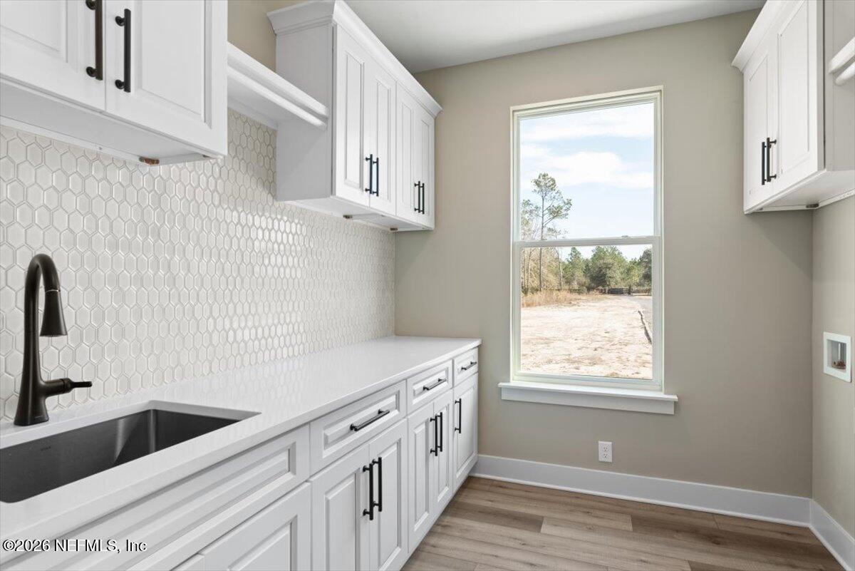 34883 Steeple Chase Way Callahan, FL 32011 - Photo 20 of 88 a kitchen with stainless steel appliances cabinets a sink and a window