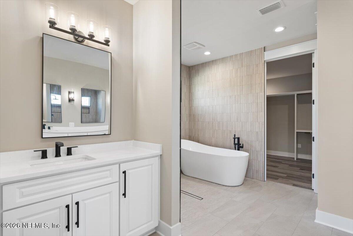 34883 Steeple Chase Way Callahan, FL 32011 - Photo 23 of 88 a bathroom with a sink and a mirror