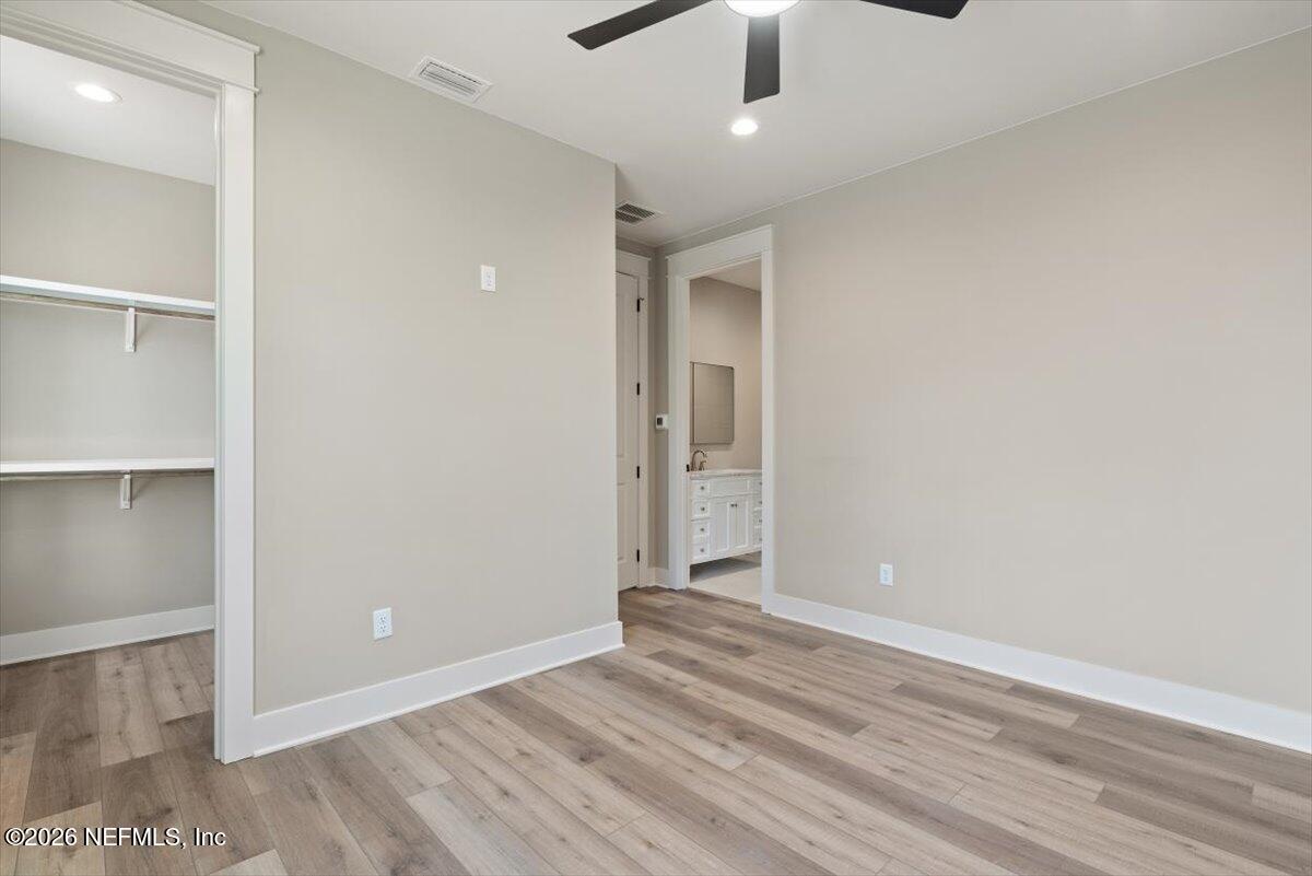 34883 Steeple Chase Way Callahan, FL 32011 - Photo 29 of 88 an empty room with wooden floor closet and windows