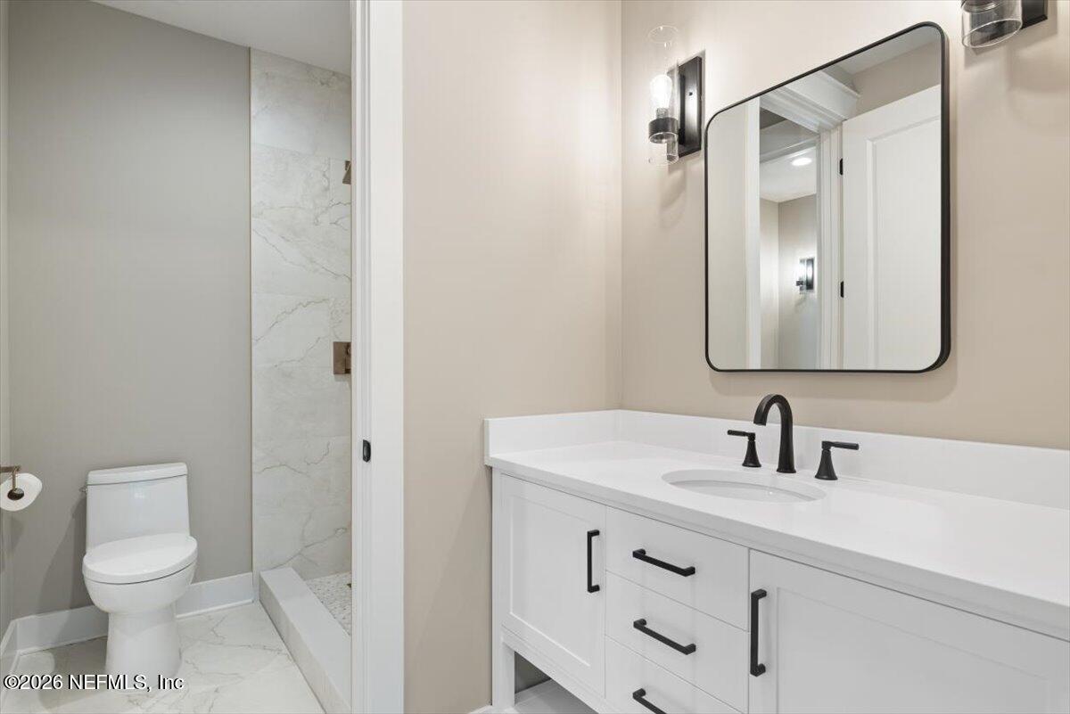 34883 Steeple Chase Way Callahan, FL 32011 - Photo 32 of 88 a bathroom with a toilet a sink a mirror and vanity