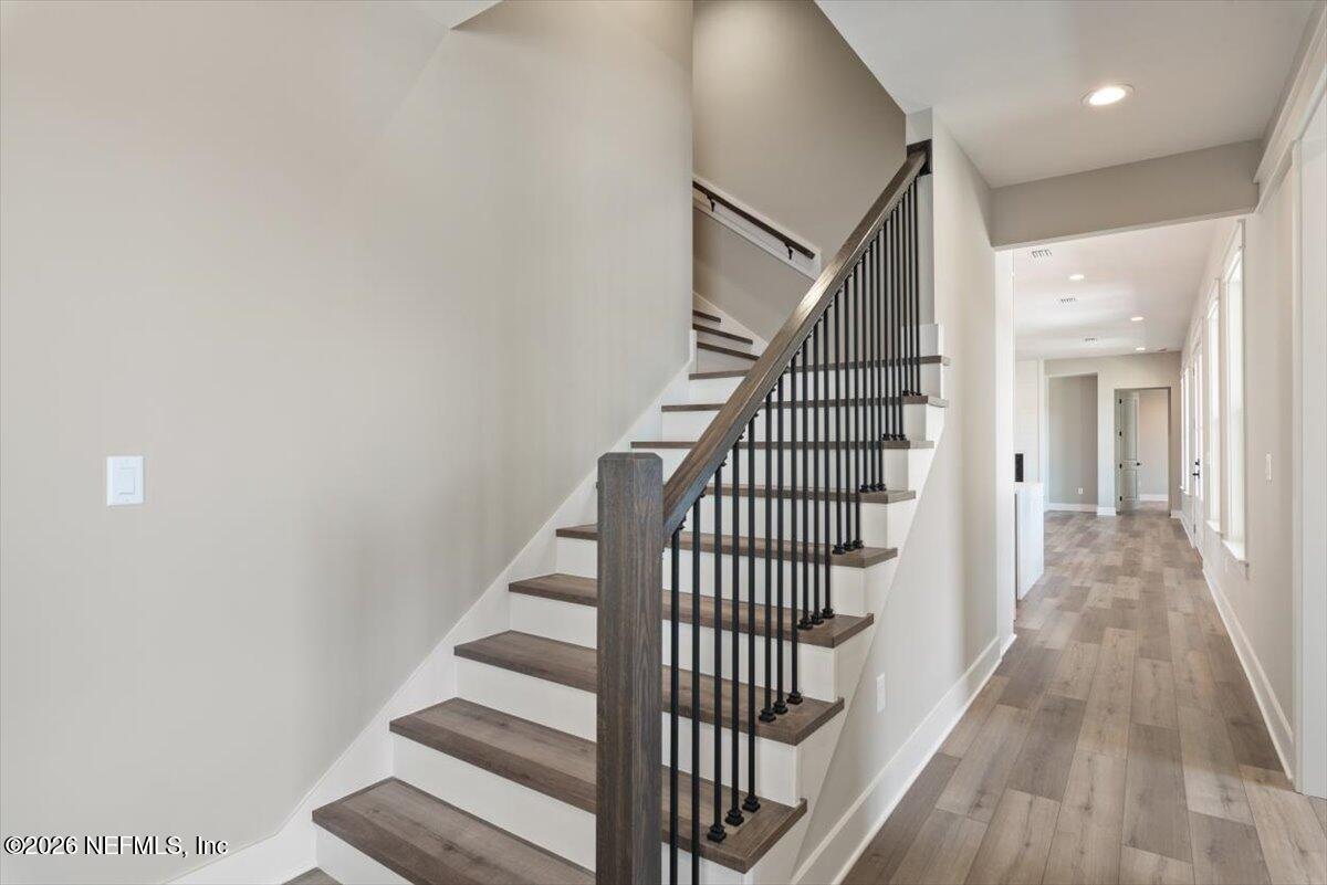 34883 Steeple Chase Way Callahan, FL 32011 - Photo 36 of 88 a view of staircase with wooden floor and white walls