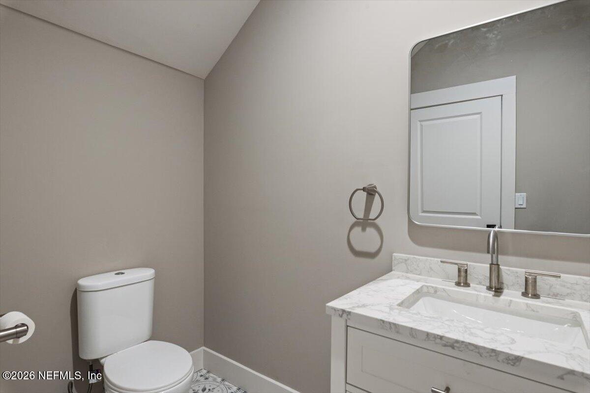 34883 Steeple Chase Way Callahan, FL 32011 - Photo 42 of 88 a bathroom with a granite countertop toilet sink and mirror