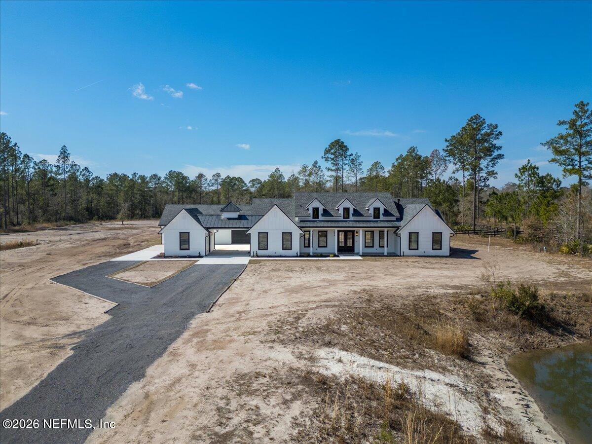 34883 Steeple Chase Way Callahan, FL 32011 - Photo 5 of 88 a view of a large house with a big yard and large trees